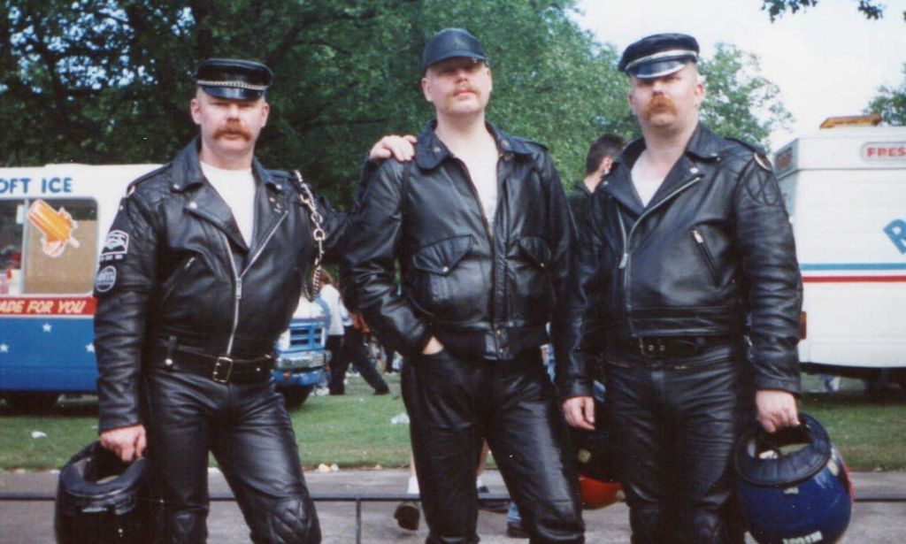 Stuart Conroy (died 20 August 1992), Tomas Jerkestad (died spring 1994), and Steve Craftman, who is still alive today, pictured at a Pride event in 1989. The three men are dressed in leather.