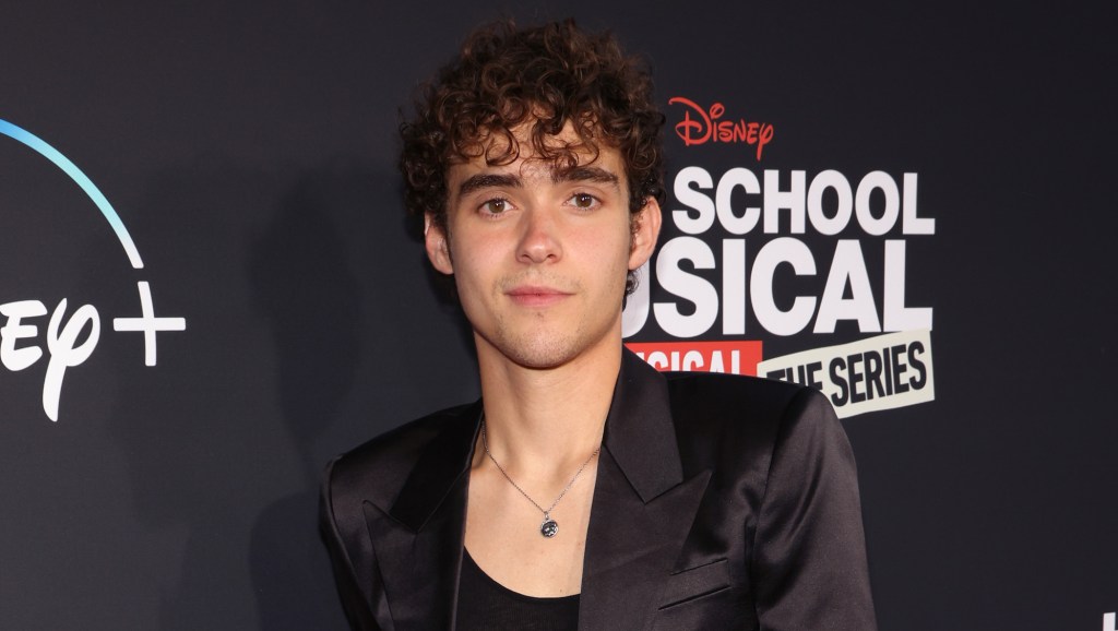 High School Musical star Joshua Bassett in a black vest and suit jacket