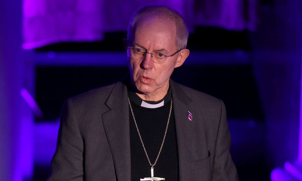 Justin Welby speaks during an event while wearing a grey blazer and black sweater.