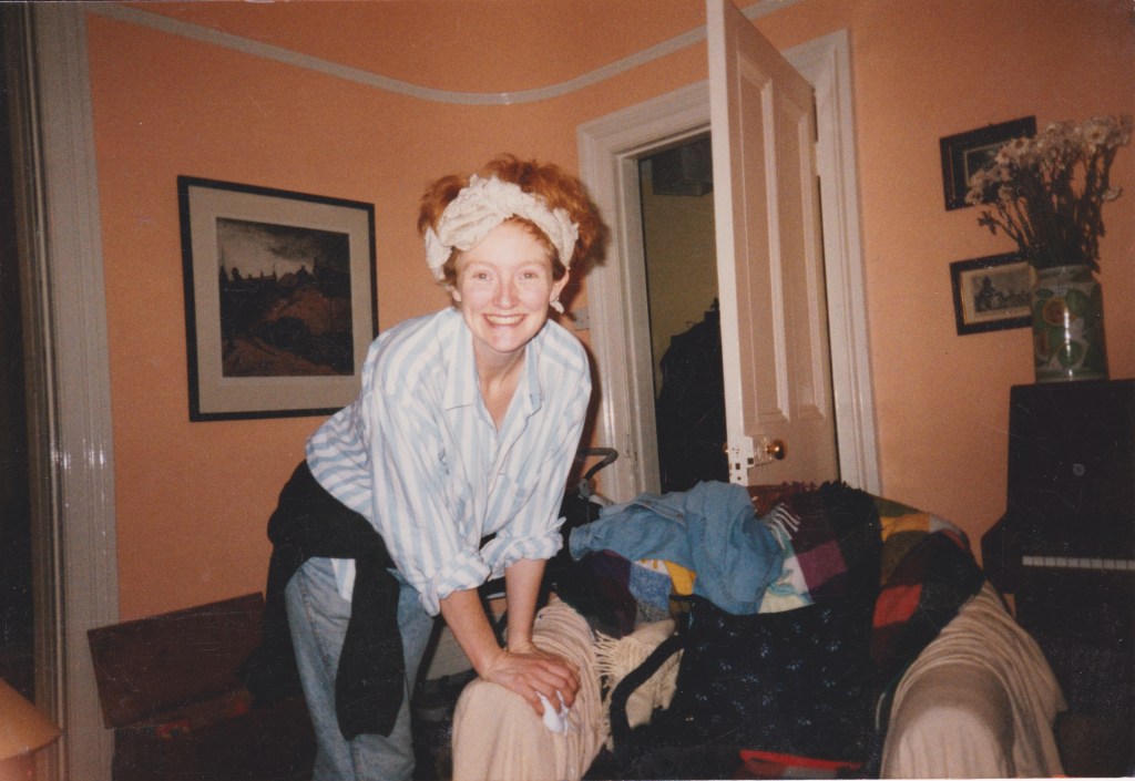 Kelly Hunter, an AIDS activist, pictured in the 1980s. She is indoors in a house wearing a baggy shirt and a headband.