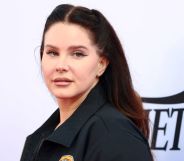 Lana Del Rey is wearing a black jacket and looking off to the side while on the red carpet at the 2021 Variety Hitmakers Brunch.