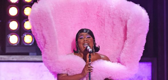 Lizzo wearing a fluffy pink elaborate gown while performing at the Brit Awards.