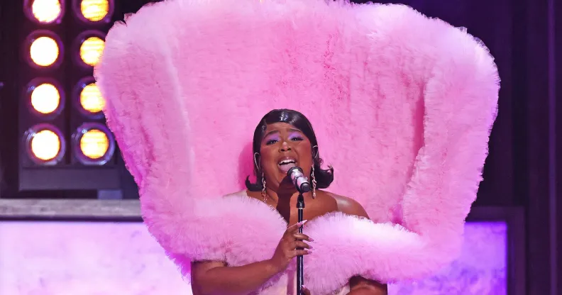 Lizzo wearing a fluffy pink elaborate gown while performing at the Brit Awards.