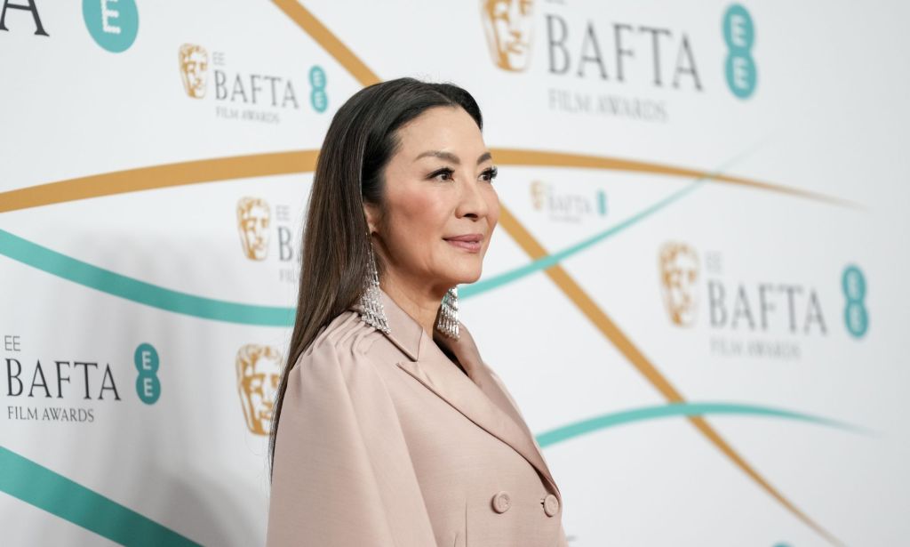 Michelle Yeoh in a beige suit on the red carpet at the 2023 BAFTA Awards.