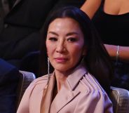 Michelle Yeoh looks down while seated at the 2023 BAFTA Awards ceremony.