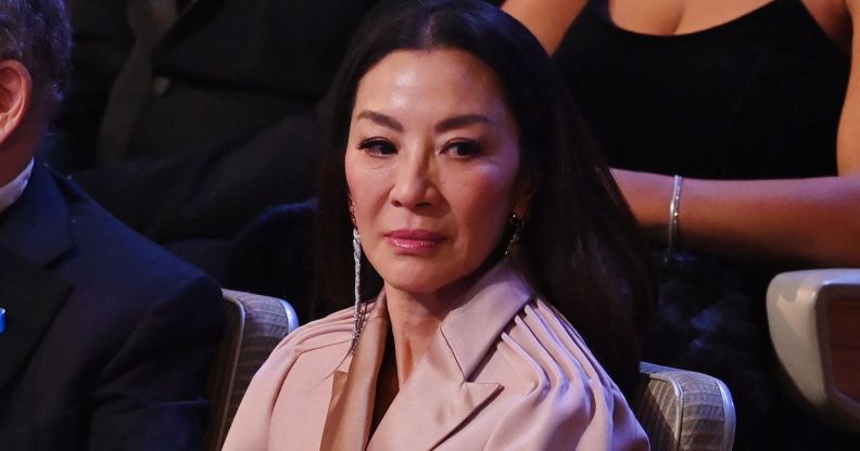 Michelle Yeoh looks down while seated at the 2023 BAFTA Awards ceremony.