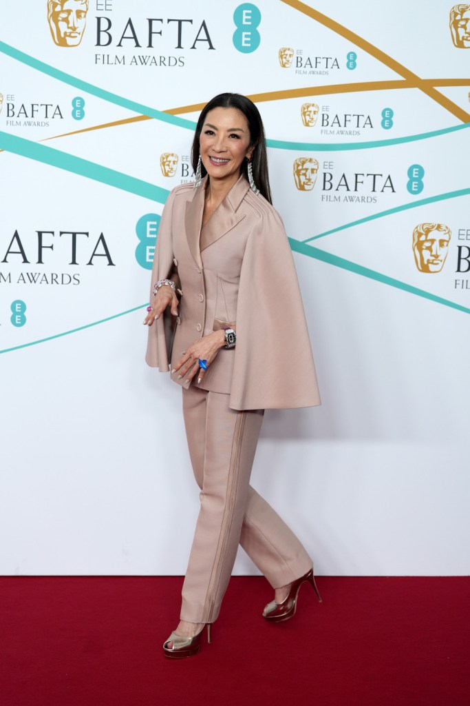 Michelle Yeoh wears a beige suit on the 2023 BAFTA red carpet.