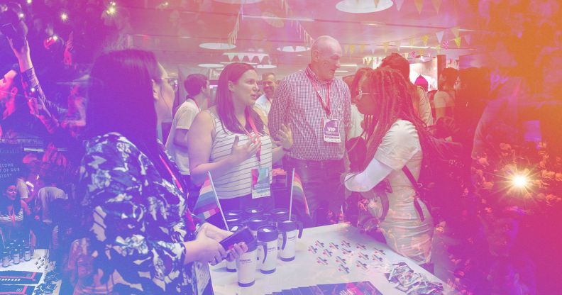 A woman is speaking to another person in a fairly crowded room.