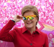 Nicola Sturgeon wearing sunglasses. The lenses show the pride and trans flags.