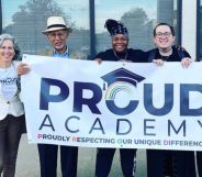 A photo showing lesbian teacher Patricia Nicolari (left), with members of the PROUD Academy board holding a sign saying "PROUD Academy"