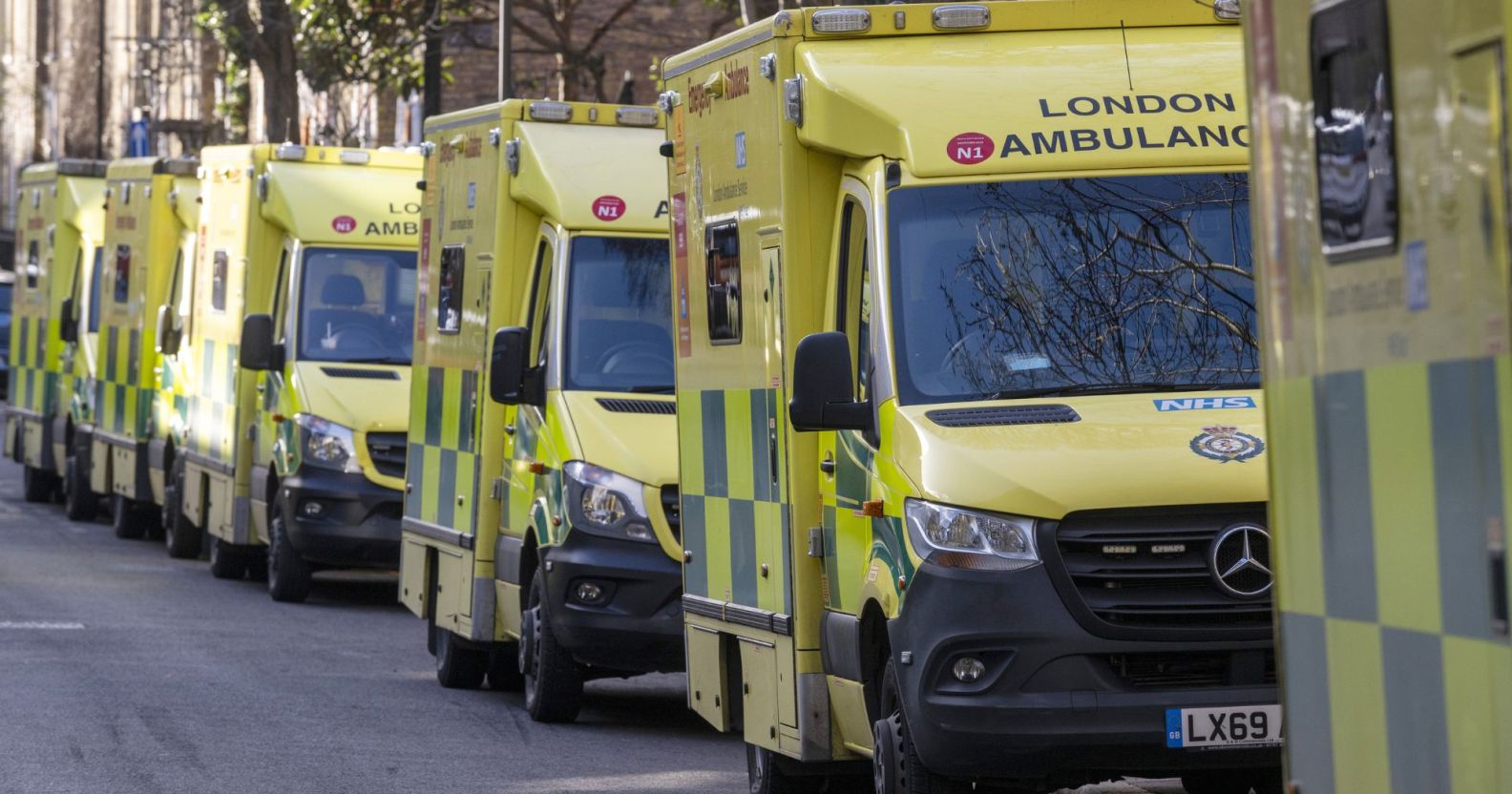 Several ambulances driving through London.