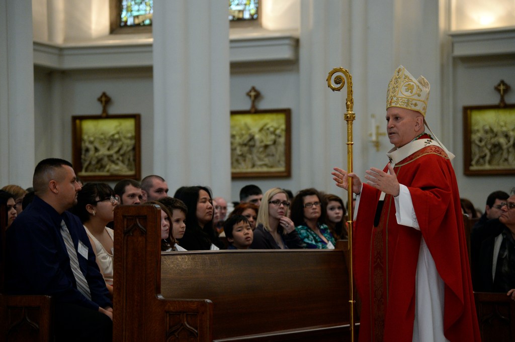 Children and adults receive the Rite of Confirmation at Cathedral Basilica of the Immaculate Conception