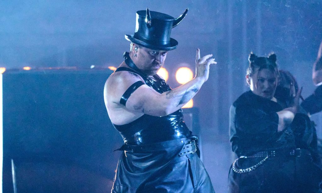 Sam Smith performs at the Brit Awards wearing a latex vest, top hat and devil horns.