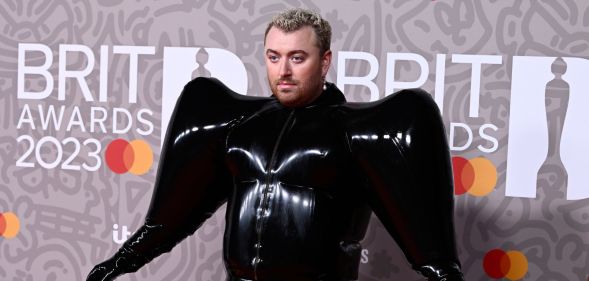 Sam Smith wearing a black Valentino latex suit on the Brit Awards red carpet.