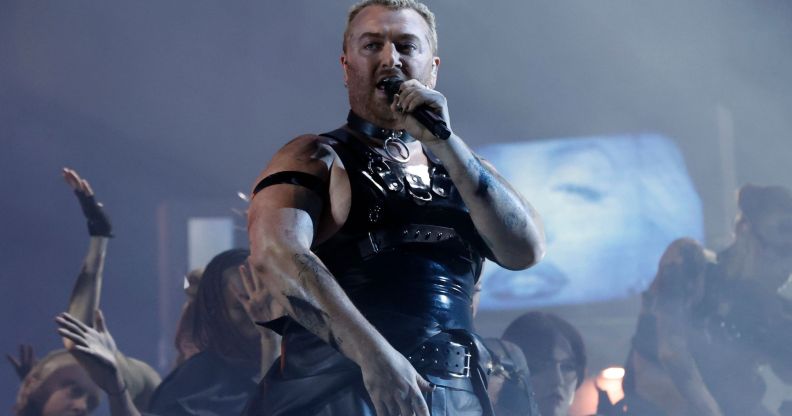 Sam Smith in a latex vest singing on stage at the Brit Awards.