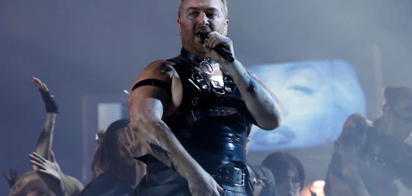 Sam Smith in a latex vest singing on stage at the Brit Awards.