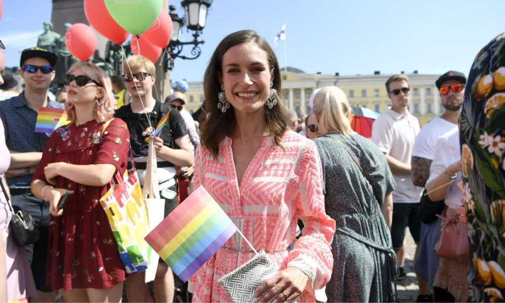 Finnish Prime Minister Sanna Marin holds a rainbow flag