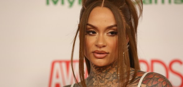 A close-up photo of singer Kehlani showing various tattoos on the top half of her body as she is seen at am awards event