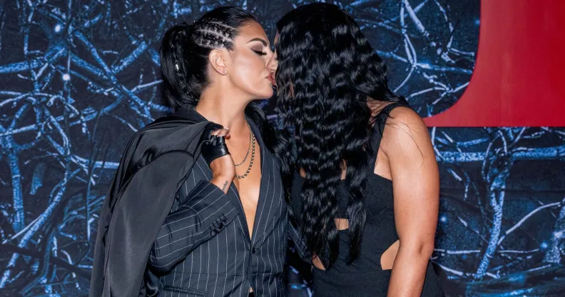Sonya Deville and her girlfriend kiss one another.