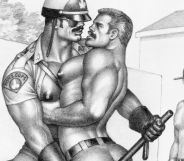 One of Tom of Finland's drawings. It shows a police officer grabbing a muscular shirtless man seductivley while another man watches on.