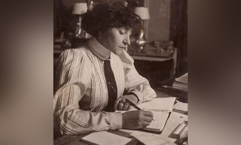 Sidonie-Gabrielle Colette, better known as Colette, writes at a desk in this monochrome photograph of the queer French author