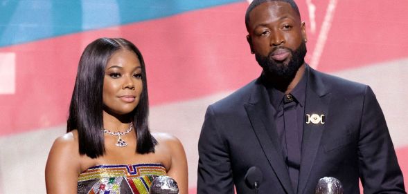 A graphic of Gabrielle Union and Dwyane Wade with a trans Pride flag in the background as they honour their trans child, Zaya, and the LGBTQ+ community during their NAACP Image Awards speech