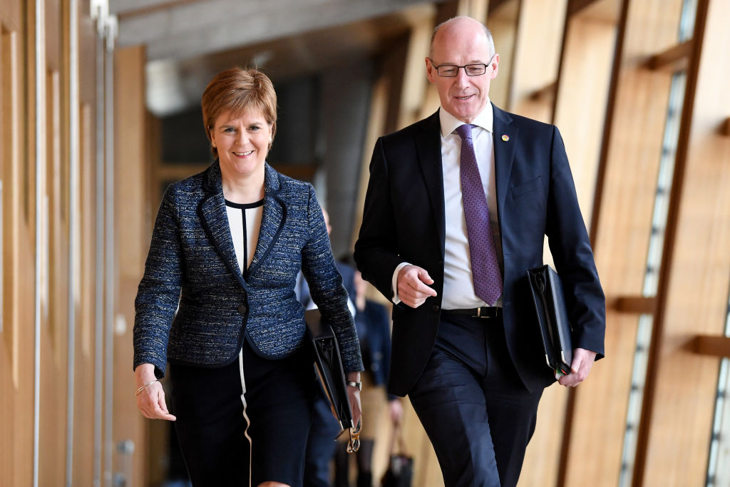 Nicola Sturgeon and John Swinney arrive for first minister's questions in the Scottish Parliament on March 8, 2018.