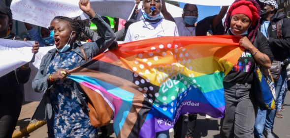Demonstrators are seen marching with an LGBTQ flag during a protest in Nairobi.