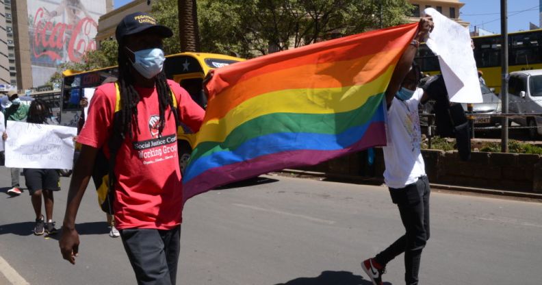 Demonstrators are seen marching with an LGBTQ+ flag during a protest in Nairobi.