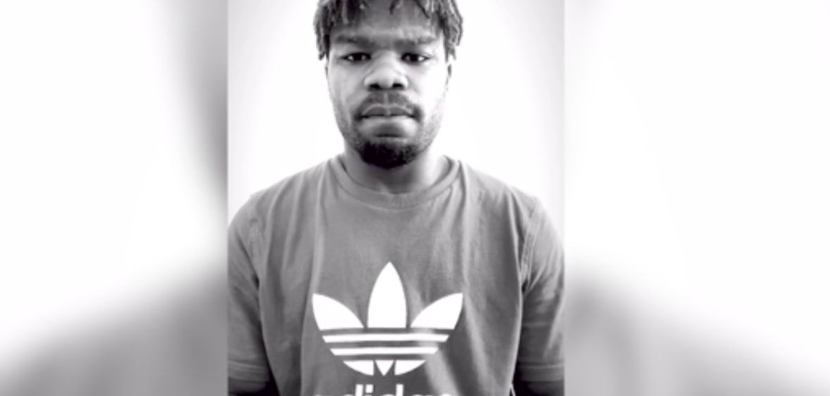 A black and white screenshot of missing rugby player Levi Davis' video shows the player wearing a t-shirt with the Adidas logo on it