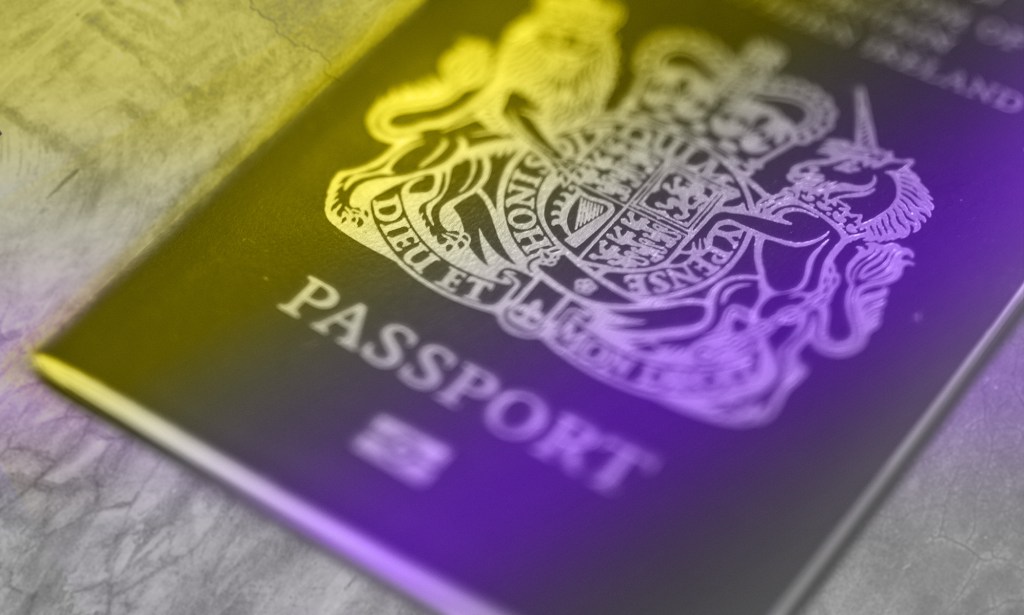 A British passport with the non-binary flag colours washing over it