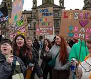 A photo showing trans rights protesters in Glasgow holding placards with messages saying "Lesbians love trans women"