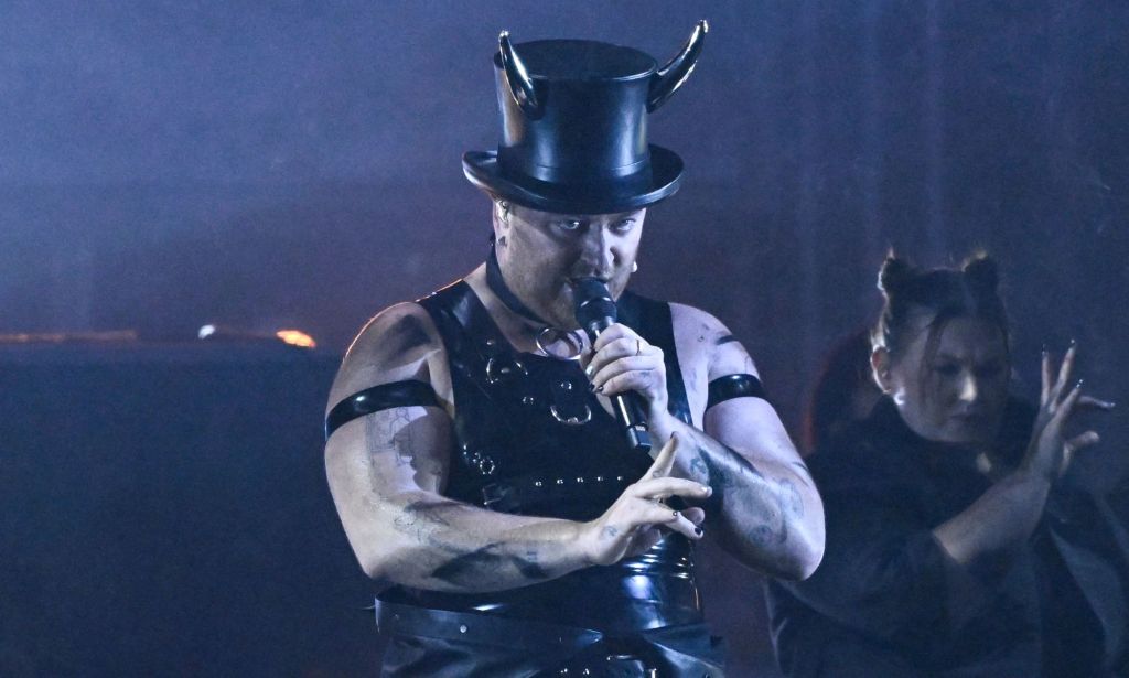 Sam Smith wears a horned top hat while they perform their song 'Unholy' at the 2023 Brit Awards