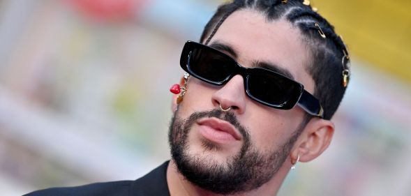 Bad Bunny wearing glasses and pouting.