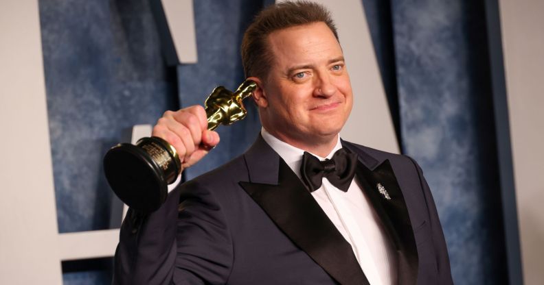 Brendan Fraser holds up his Best Actor Oscar.