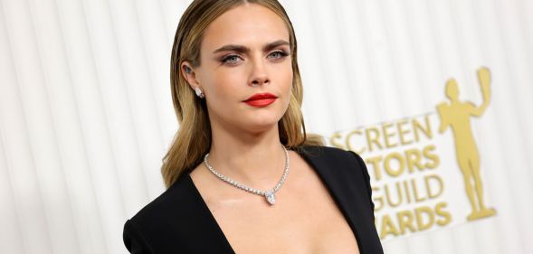 Cara Delevingne wears a black dress and silver chain at the Screen Actors Guild Awards.
