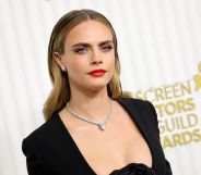 Cara Delevingne wears a black dress and silver chain at the Screen Actors Guild Awards.