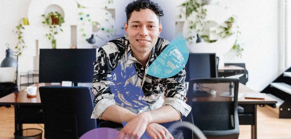 This is an image of a masculine presenting person in an office setting