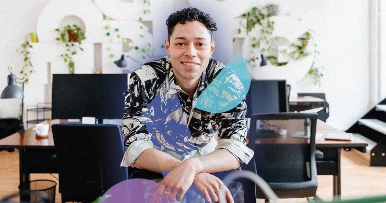 This is an image of a masculine presenting person in an office setting