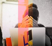 A woman is stressed behind her computer. She has her hands on her head.