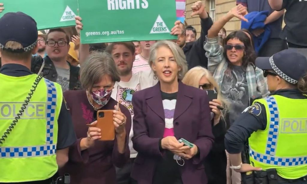 Tasmania Greens MPs Cassy O'Connor and Rosalie Woodruff standing in a pro-trans crowd.