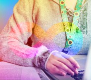 A person is working at their computer. Their face isn't visible in this image. They are wearing the sunflower lanyard which signifies disability.