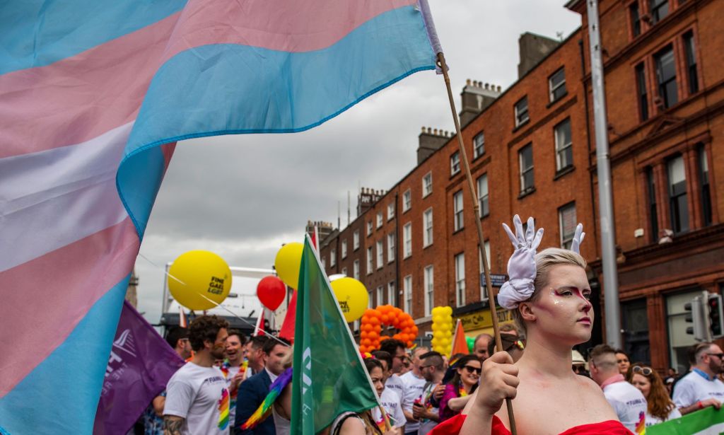 Trans Pride in Dublin, a person waves a trans flag.