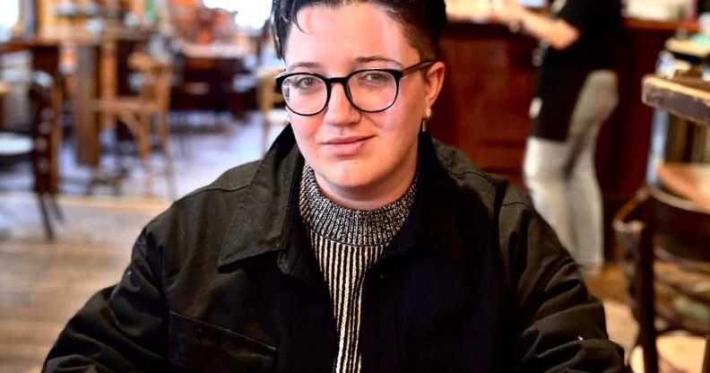 Jack Hyslop, who lives with endometriosis, pictured in a cafe.