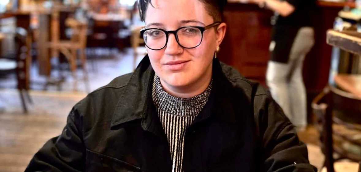 Jack Hyslop, who lives with endometriosis, pictured in a cafe.