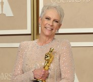 Jamie Lee Curtis hold Oscar statuette smiling, after winning Best Supporting Actress for Everything Everywhere All At Once.