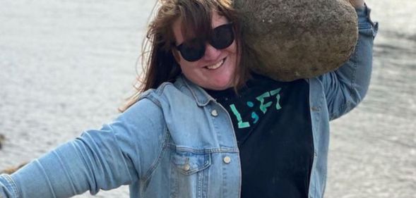 JayCee Cooper lifting a rock