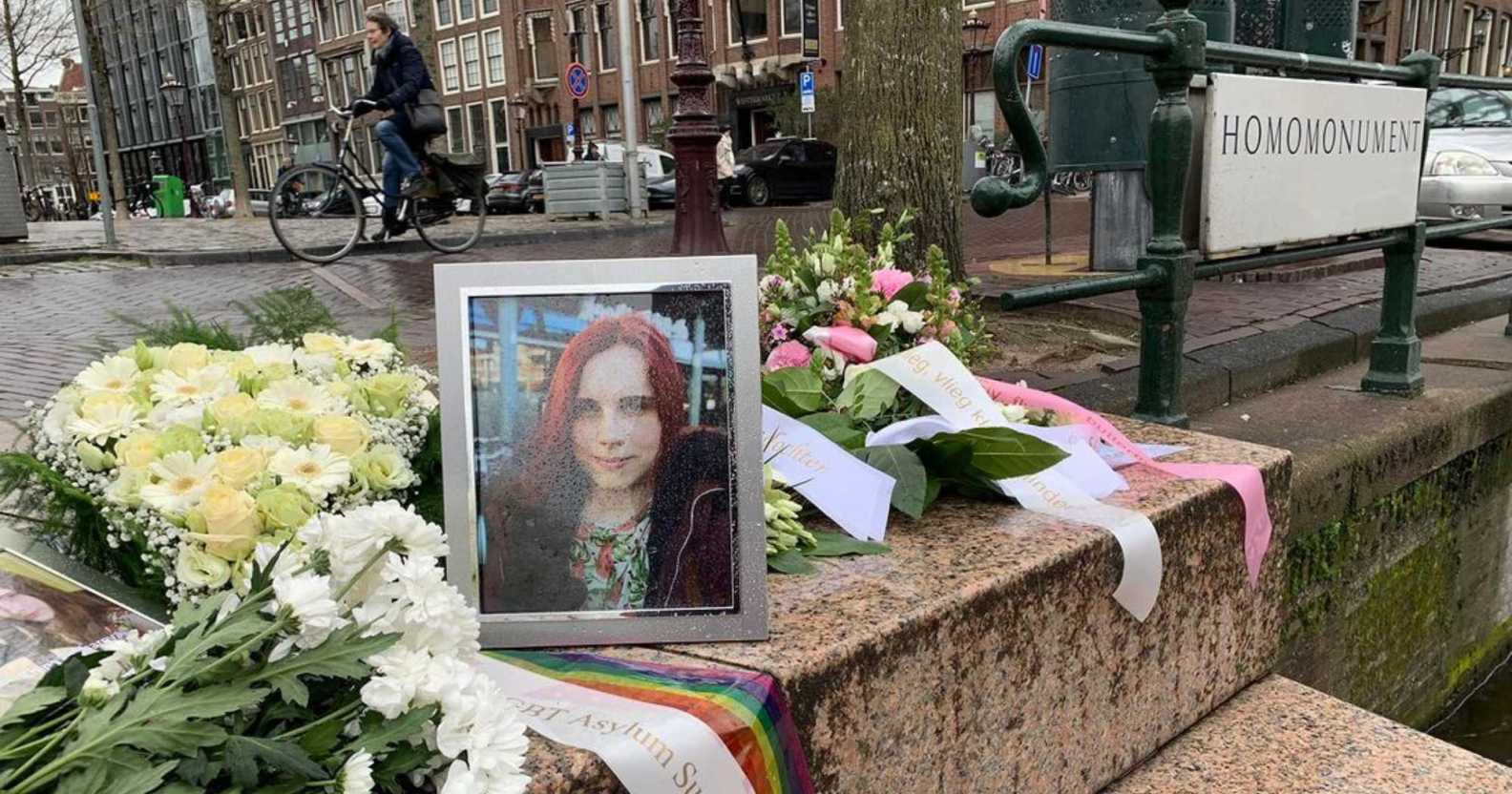 Flowers laid next to Khina Zakharova's photograph