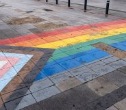 A pavement with an LGBT Pride flag on the tiles.