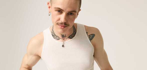 Model Oscar McGregor wearing a white vest top